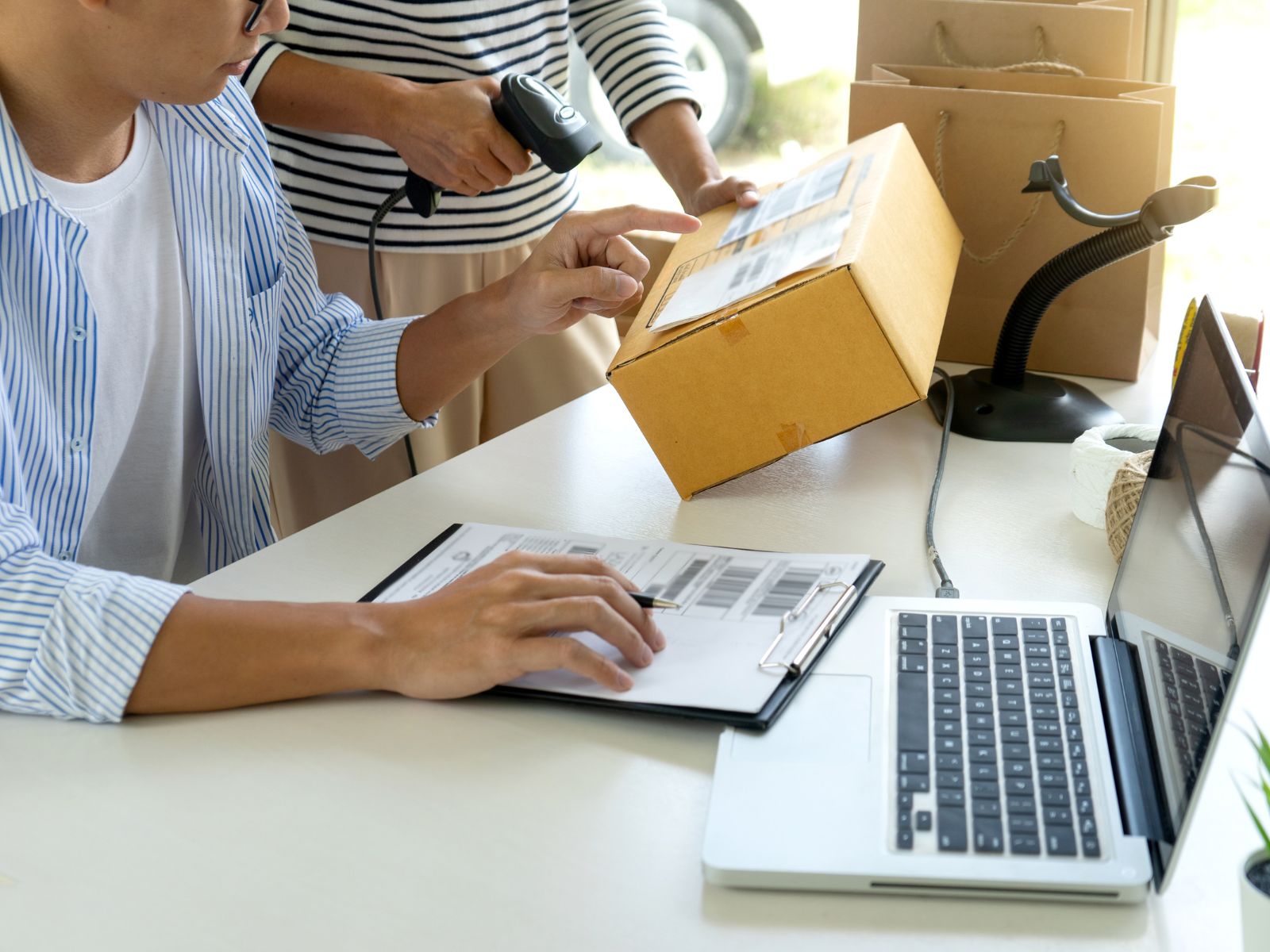 Online store staff scanning a parcel for delivery