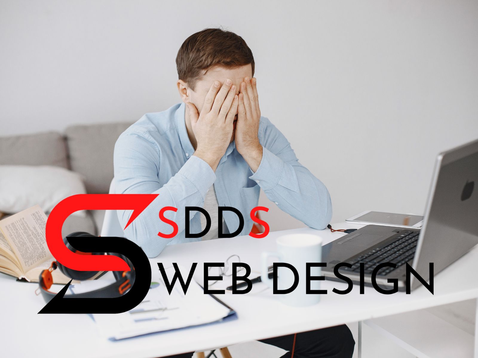 Frustrated man sitting at a computer with the SDDS Web Design logo