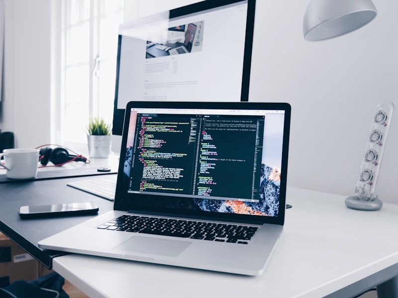 Website developer working with code on a laptop